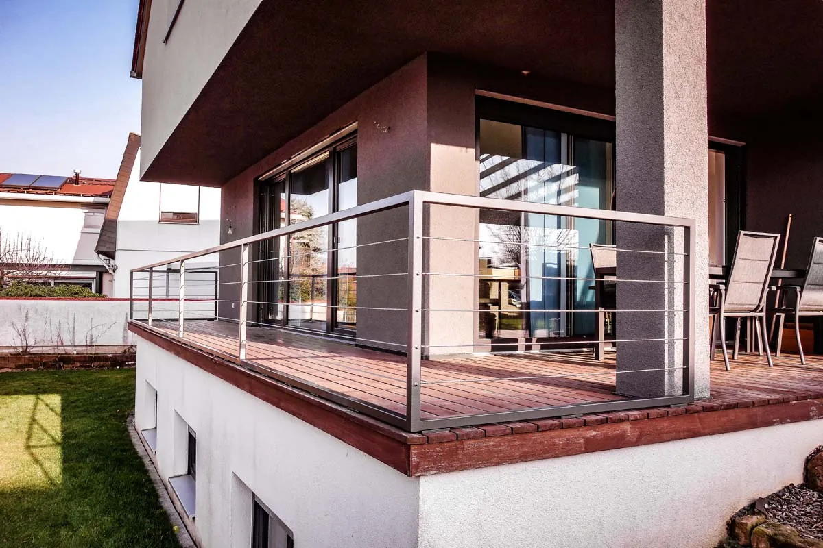 Balkongeländer aus Edelstahl mit Seilfüllung an Holzterrasse
