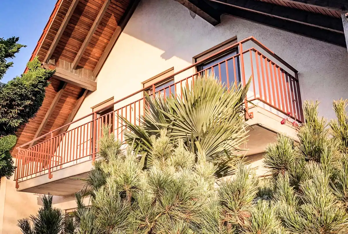 Balkongeländer aus Stahl mit farbiger Flachstabfüllung am Einfamilienhaus